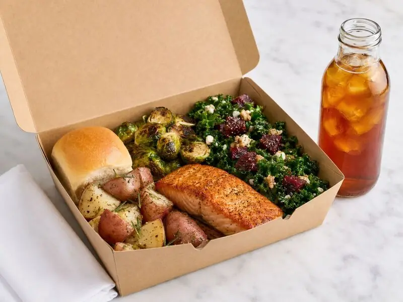 Napa Catering Company prepared meal combining spice-rubbed salmon, seasonal vegetables, roasted potatoes, artisan bread, and bottled tea.