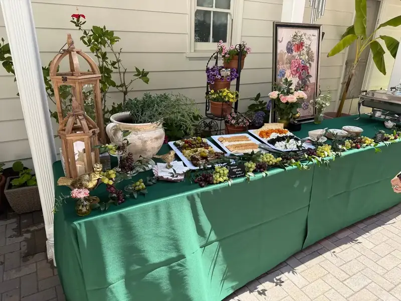 Napa-inspired entertaining table showcasing grazing platters, fresh grapes, artisan snacks, flowers, and rustic decorative pieces.